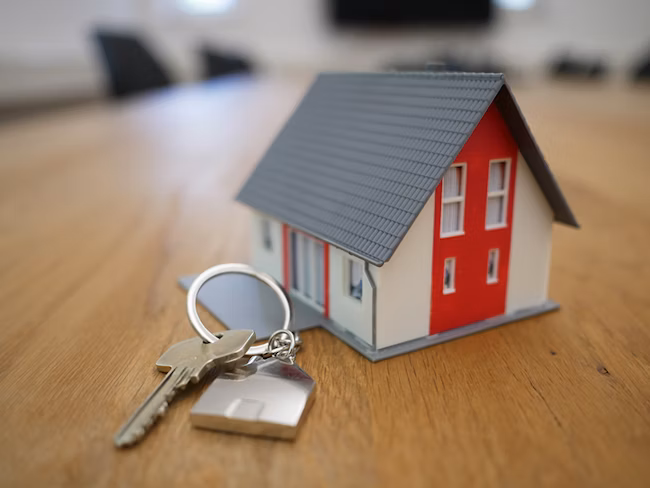 Small house model with a key along side it
