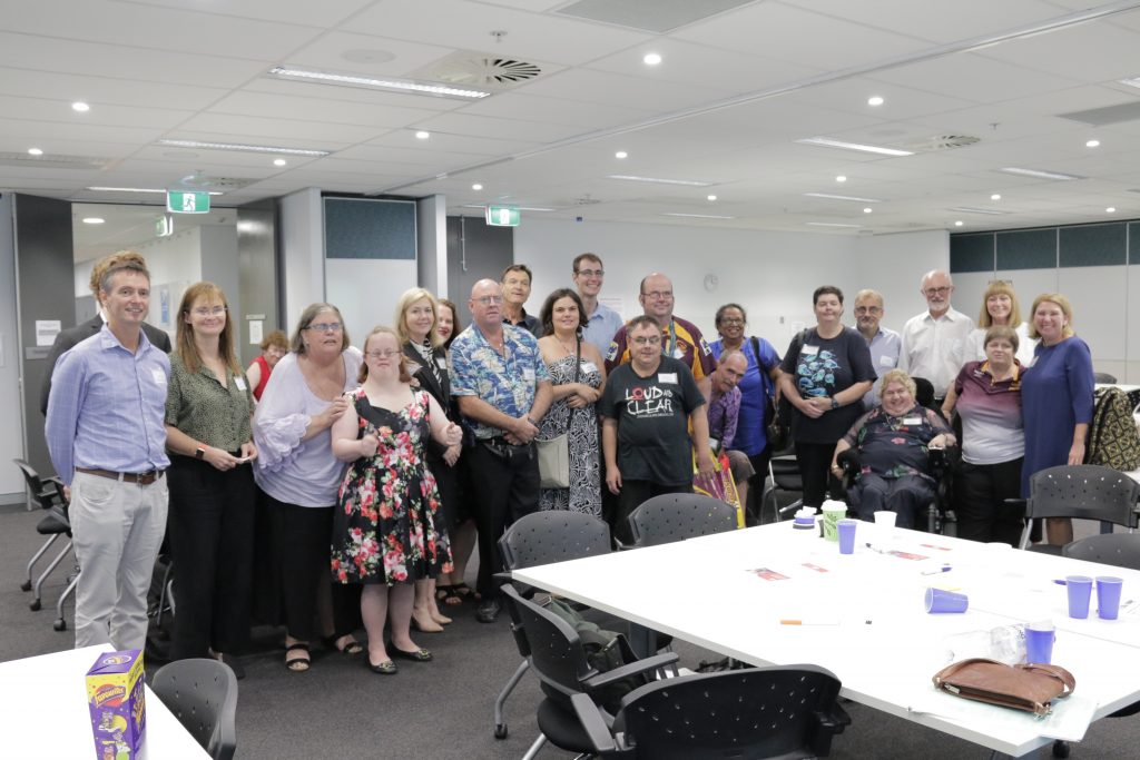 A photo of a gorup of 21 people looking at the camera
