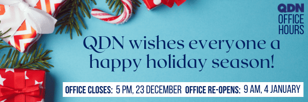 There is an aqua background with some pictures of red and white striped presents with some greenery. In the top left it says QDN Office Hours. The main text says QDN wishes everyone a happy holiday season! Office Closes 5pm, 23 December, Office re-opens 9am, 4 January. 