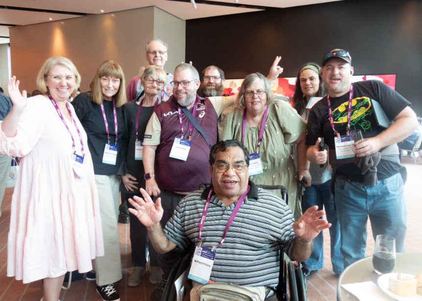 QDN Members and Staff smiling at the camera for a group photo at the Australasian Society for Intellectual Disability (ASID) 2023 conference. 