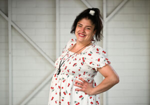 Woman wearing a white and red flower-patterned dress