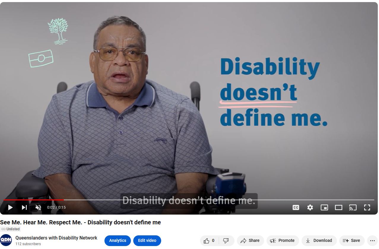 Screen clipping of linked YouTube video. There is a man to the left of the screen in a blue collared shirt, with an Aboriginal Flag and Tree icon to his left. To the right in navy blue text is Disability doesn't define me. At the bottom of the screen clipping there is the YouTube banner, with play, pause, skip buttons.