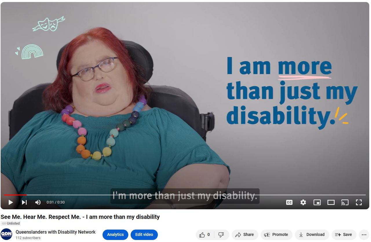 Screen clipping of linked YouTube video. There is a woman to the left of the screen in a green shirt and a rainbow colored necklace, with a rainbow and drama and tragedy icons to her left. To the right in navy blue text is I am more than just my disability. At the bottom of the screen clipping there is the YouTube banner, with play, pause, skip buttons.