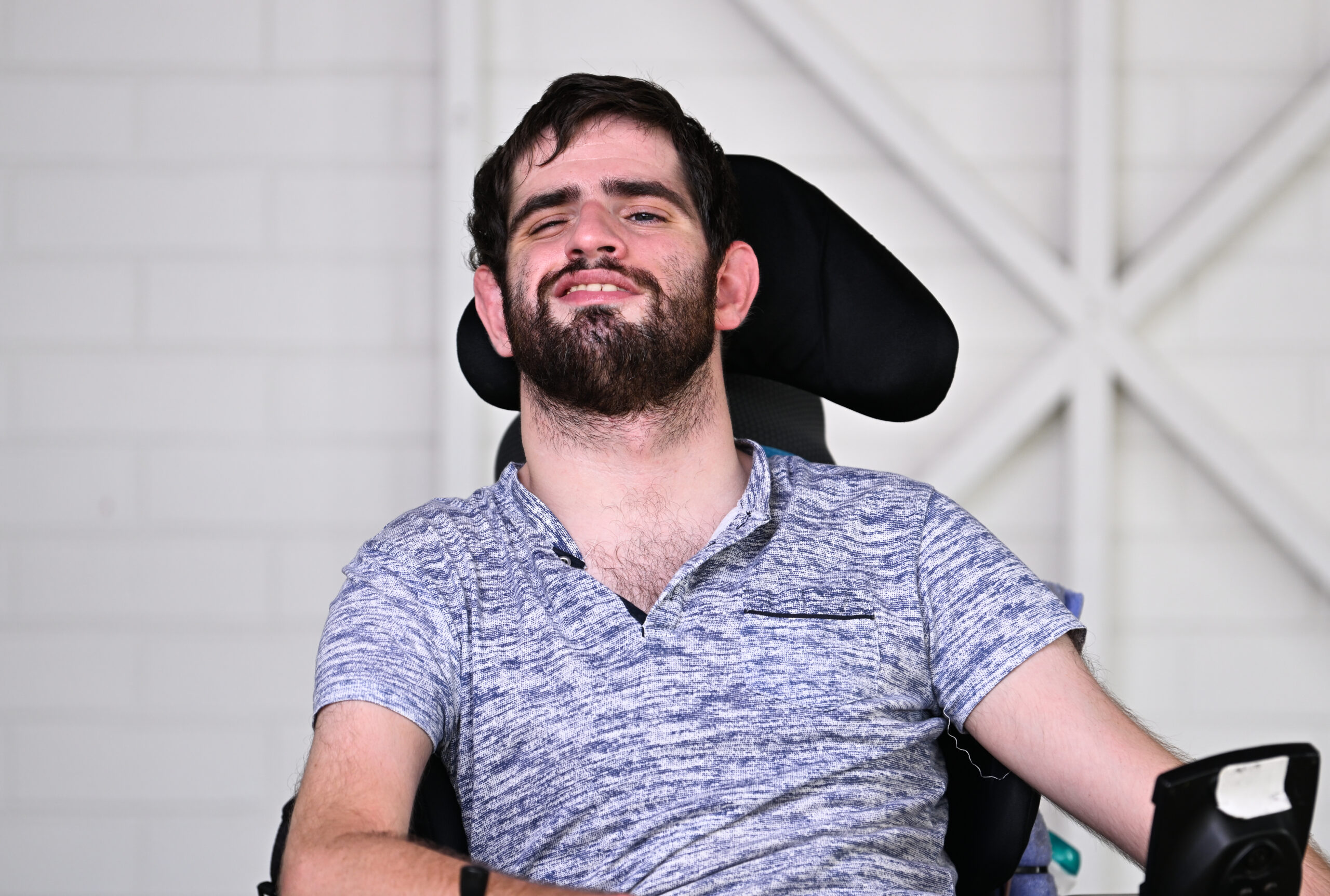 Man sitting on his wheelchair and smiling to the camera