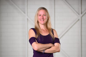 Woman with a blond hair smiling to the camera