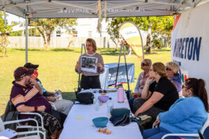 People gathered around a table at a park.