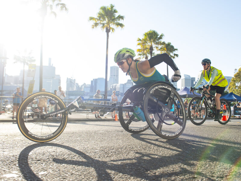 a woman in a racing wheelchair