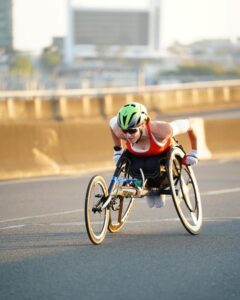 a woman in a racing wheelchair