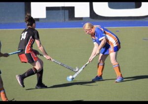 two women playing hockey