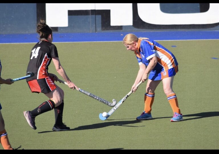 two women playing hockey