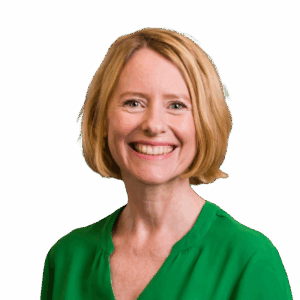 Woman in a green dress smiling at the camera