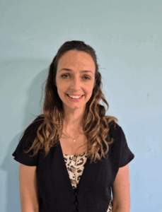 Woman with long hair and wearing a black shirt
