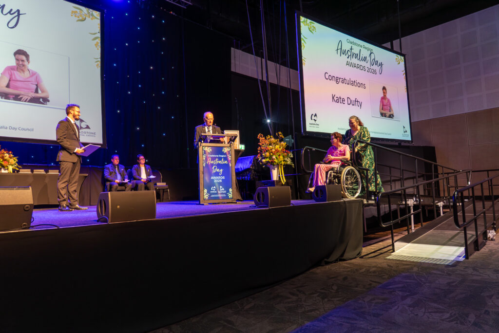 Kate on stage to receive the 2026 Community Volunteer Award at the Gladstone Regional Council’s Australia Day Awards.