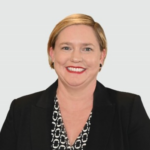 Woman with short blonde hair smiling