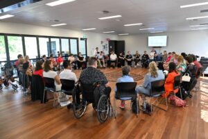 Group of people with diverse disabilities assembling in a circle.